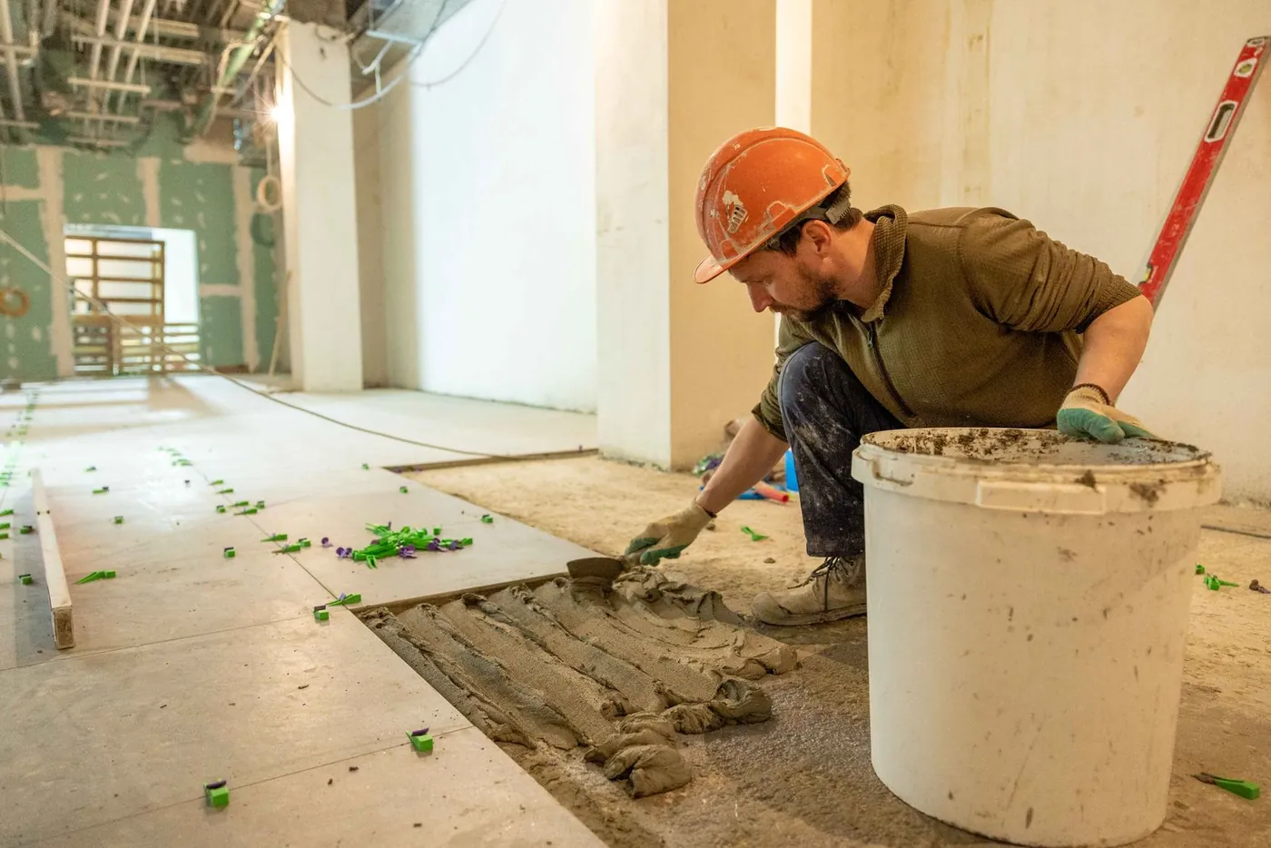 Albañil colocando el suelo de una vivienda